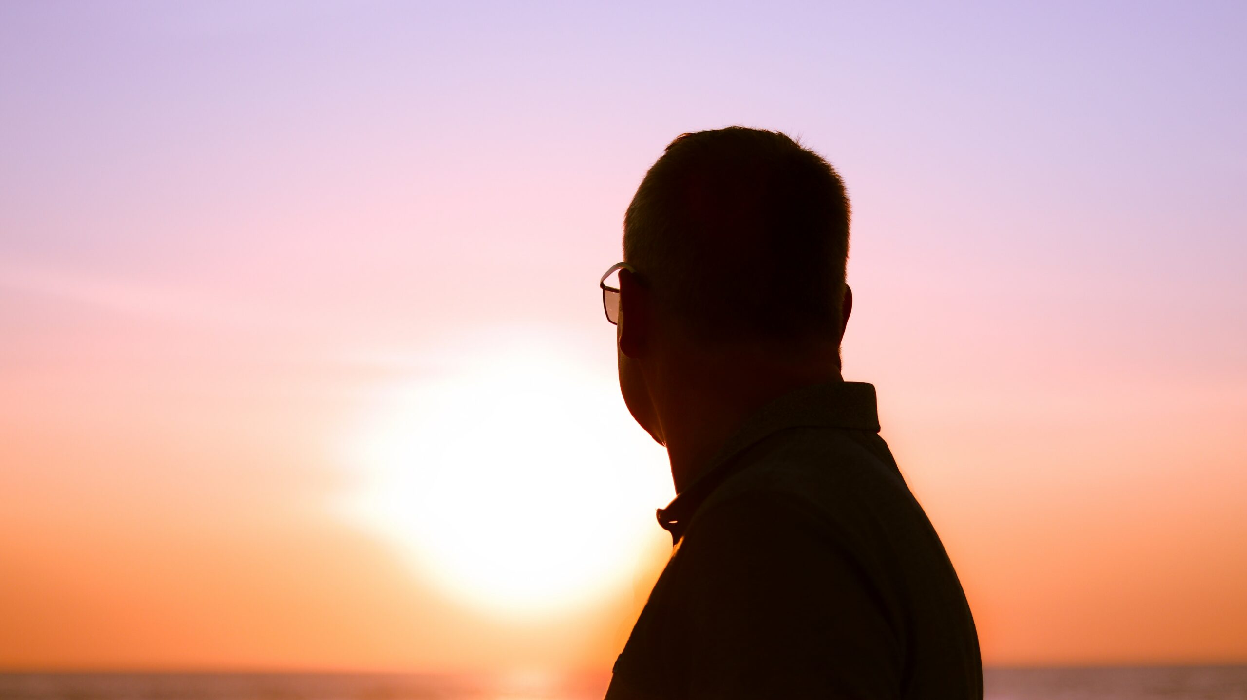 A man looking towards the sun