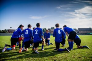 Men's soccer team huddled in a circle